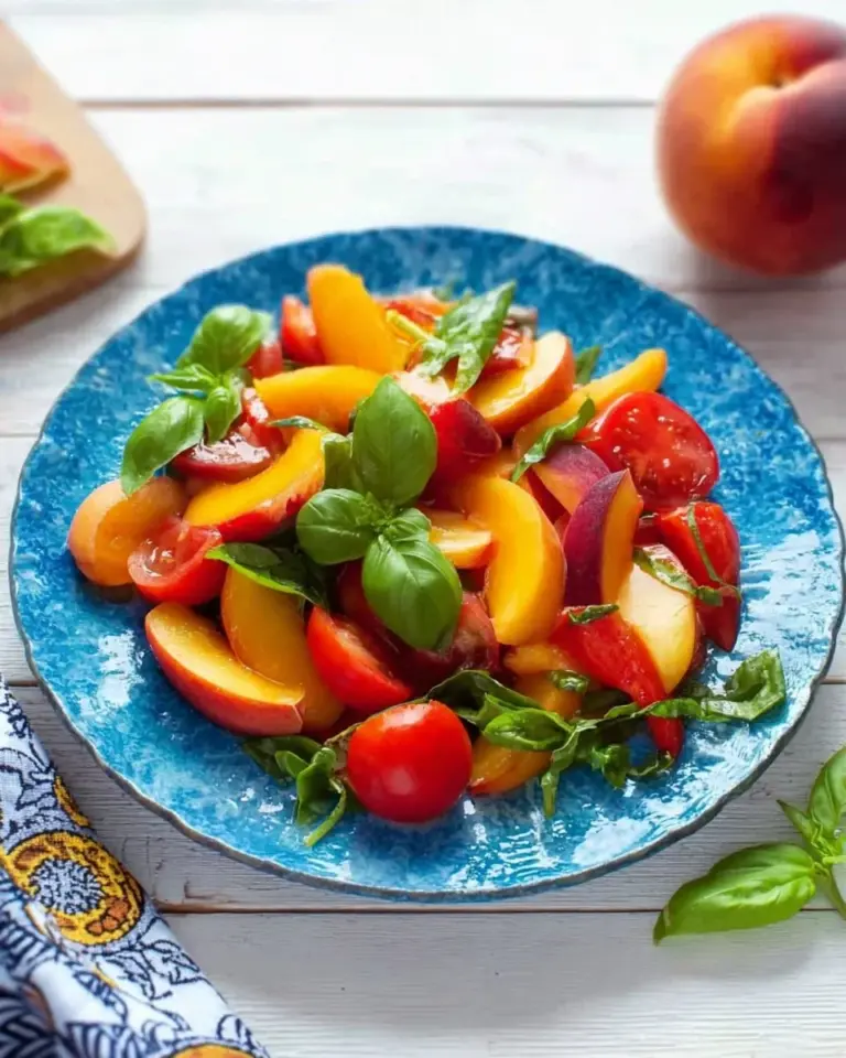 Fresh Tomato Peach Salad with Basil, showcasing vibrant colors and ingredients.