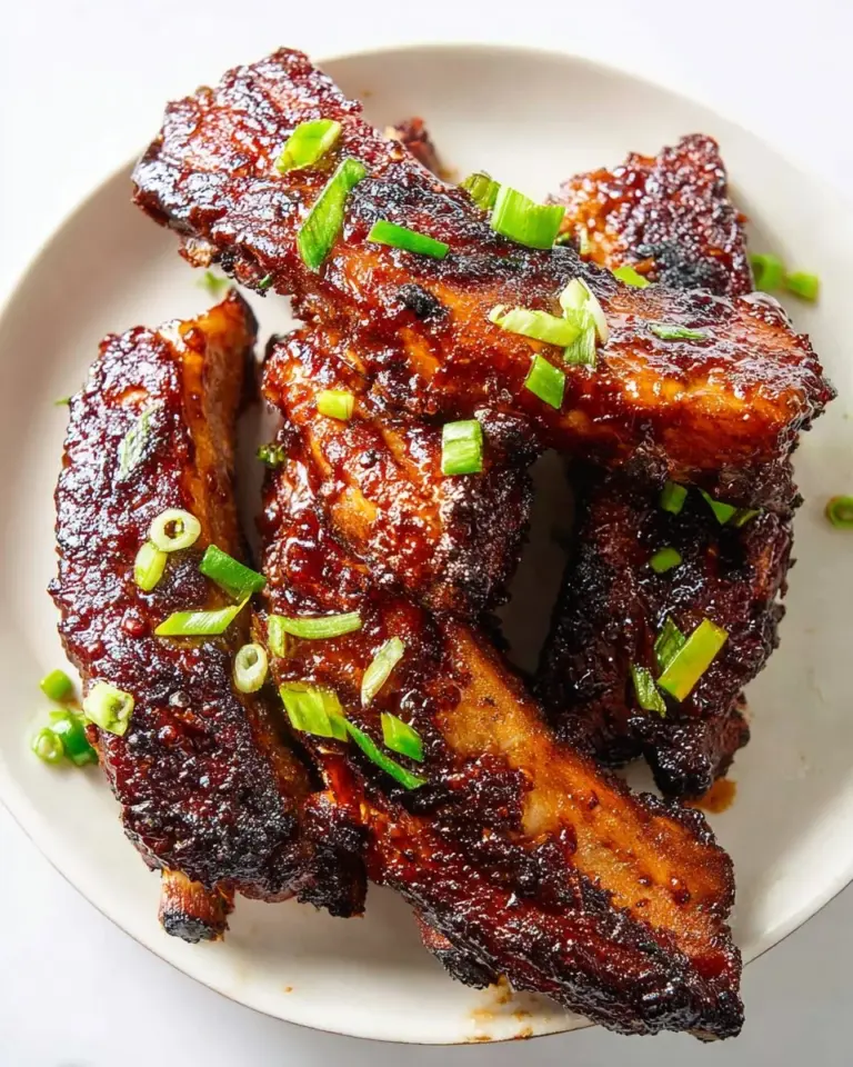 Tender Air Fryer Country Style Ribs on a plate with seasoning and sauce