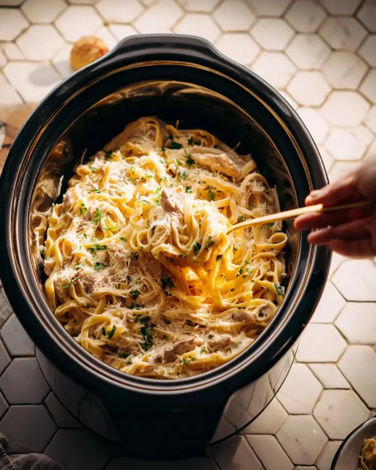 Crockpot Chicken Alfredo served in a bowl with parsley garnish