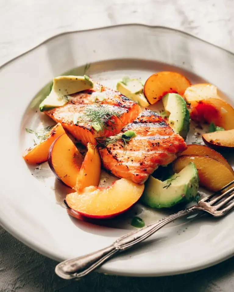 Foolproof grilled salmon, perfectly moist and flaky on a plate with garnish.