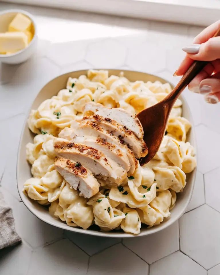 Delicious Olive Garden Asiago Tortelloni Alfredo with grilled chicken served in a bowl.