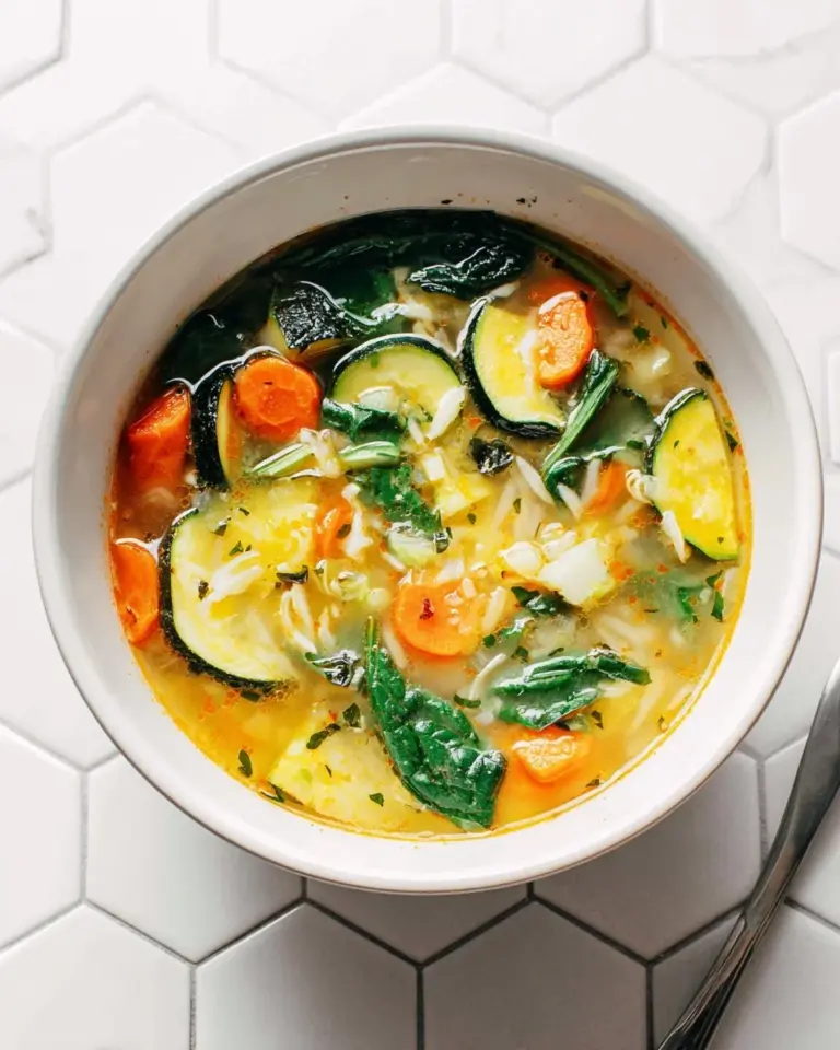 Bowl of healthy Vegetable Orzo Soup with colorful vegetables