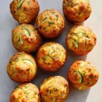 Delicious zucchini feta muffins topped with herbs, perfect for breakfast or snacks.