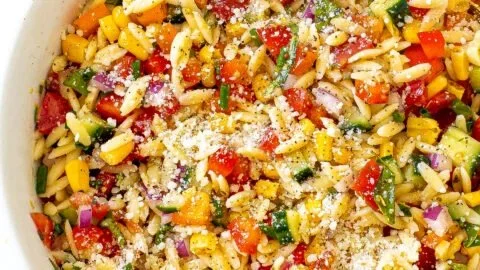 Fresh summer orzo pasta salad with vegetables and herbs