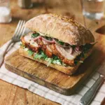 Delicious roasted pork belly sandwich with crisp vegetables and sauce
